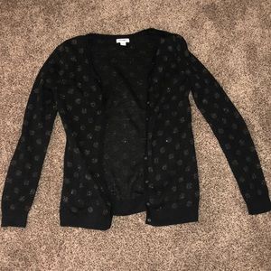 Black cardigan with polka dots.
